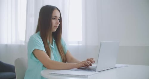 Businesswoman With Laptop In Her Office At The Desk, Working. Business Woman Works on Laptop on