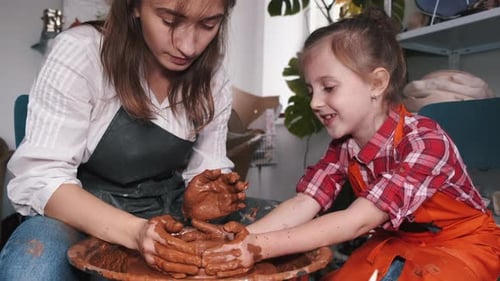 Woman and Child Making Pottery Together