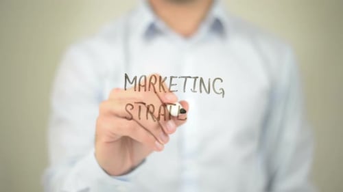 Writing Marketing Strategy on Clear Surface