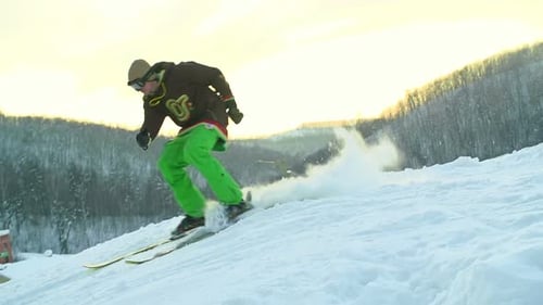 Skier Jumps Off a Snow Covered Mountain