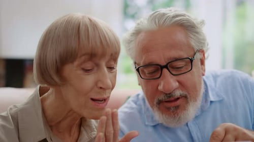 Senior Couple Using a Tablet Together Indoors