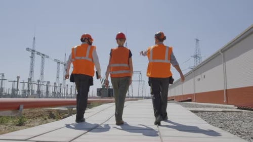 Anonymous Colleagues Walking and Talking on Power Plant