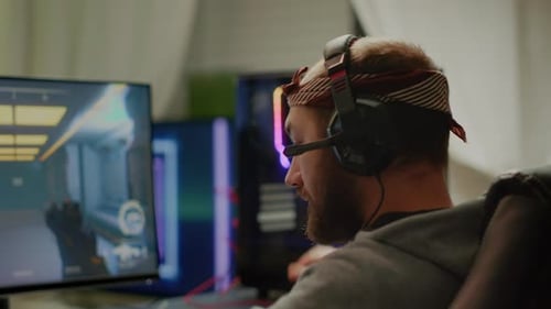 Man Playing Video Game with Headset at Home