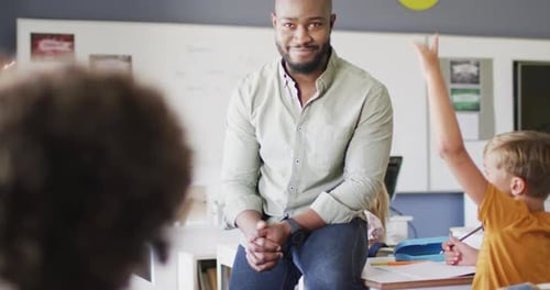Enthusiastic Class Raising Hands in School with Teacher