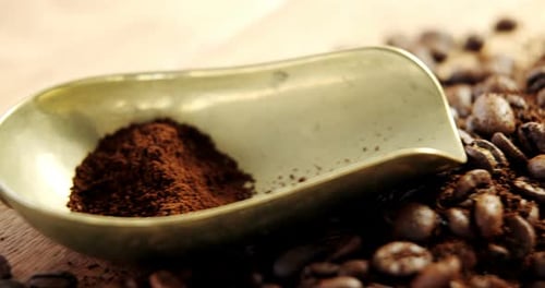 Coffee beans with powder and scoop