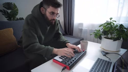 Man Plays Electronic Keyboard At Home