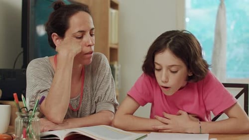 Mother Helping Child with Homework at Home