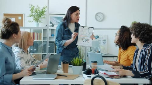 Cheerful Boss Talking To Office Workers Doing Highfive Discussing Successful Project at Work