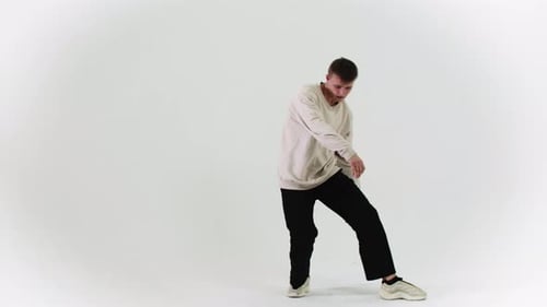 Young Stylish Man Dancing on White Cyclorama in the Studio