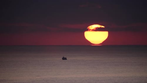 Sunrise over Sea with Fishing Boat