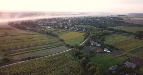 Scenic Aerial View of Foggy Village at Sunset