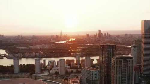 Aerial Panoramic View of City Against Setting Sun Downtown Skyscrapers in Distance