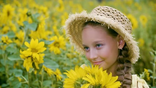 Beautiful Smiling Girl Posing with Yellow Sunflowers in Countryside