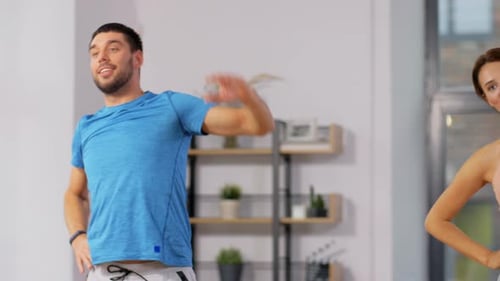 Happy Couple Exercising at Home