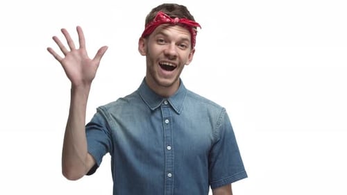 Man Smiling and Waving With Red Bandana