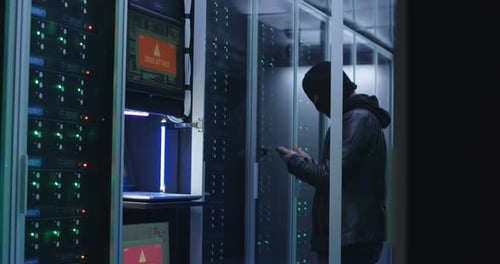 Black Man Hacking Computer System in Server Room