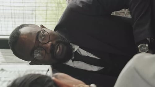 Vertical Shot of Managers Discussing Work in Cafe