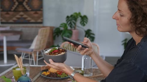 Woman Taking Photo of Meal with Smartphone