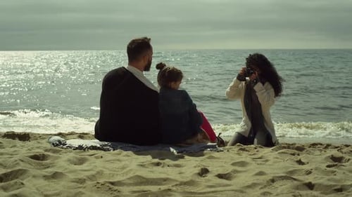 Young Family Taking Pictures on Sunny Day Beach
