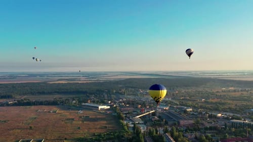 Hot Air Balloons Floating Over Idyllic Countryside