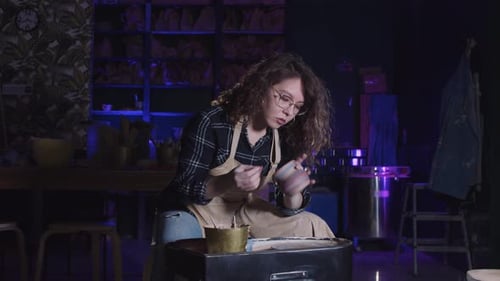 Young Adult Creating Pottery in Studio