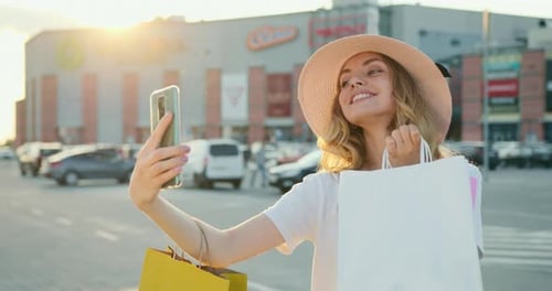 Woman Takes Selfie After Shopping at Mall