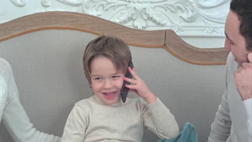 Cheerful Child Talking on Phone with Family