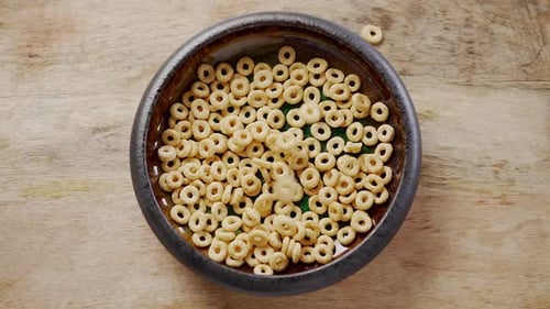 Breakfast Cereal Rings Fall Into the Ceramic Bowl