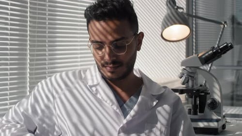 Scientist Analyzes Petri Dish Sample in Laboratory Setting