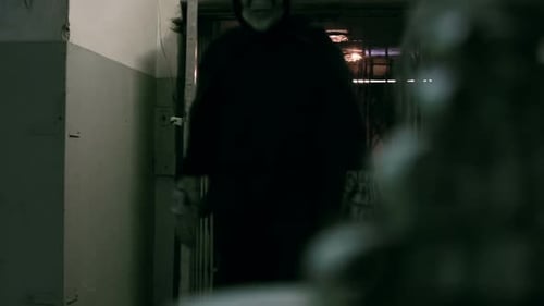 Monster in Skeleton Mask Walking Down Hallway