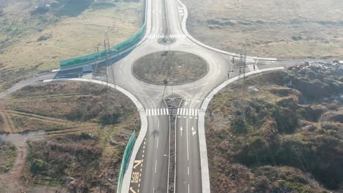 New empty four-lane road through desolate rural countryside, with clear surface marking of lanes