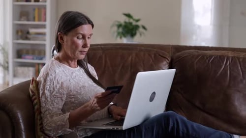 Woman Shops Online at Home with Laptop and Card