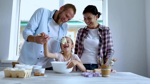 Happy Family Baking Together in Bright Kitchen