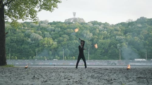 Skilled Fire Artist Performs in an Urban Park