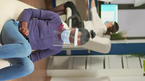 Vertical Video African Employee Holding Tablet Sitting on Armchair in Office Room