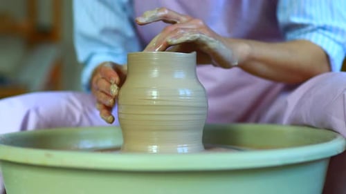 Potter Hands sculpte un vase en argile sur un potier en gros plan