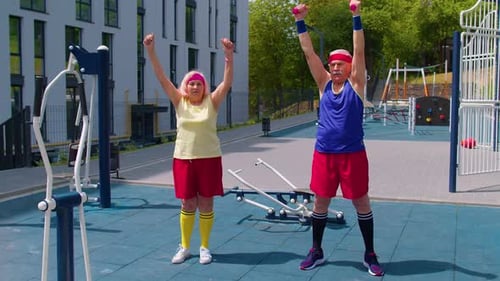 Senior Man Woman Doing Active Training Stretching Muscles Cardio Fitness Exercising on Playground