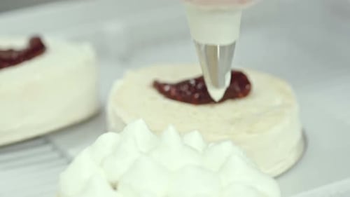 Pastry Chef Decorates Small Cake with Cream