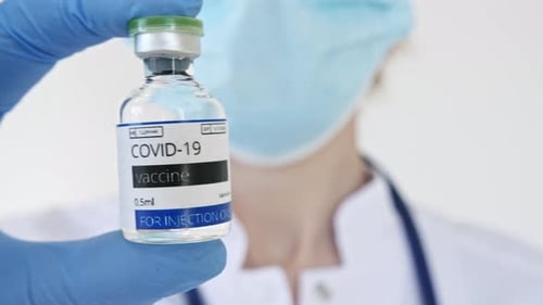 COVID19 Vaccine in Researcher Hands Doctor's Hand Holds a Vaccine Ampoule at the Hospital