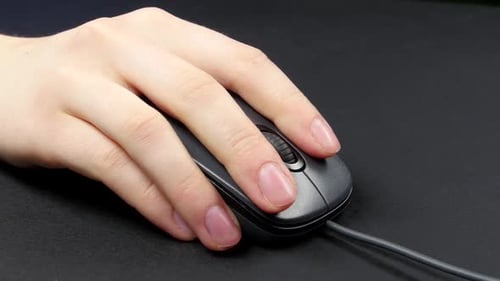 Hand Clicking and Scrolling Computer Mouse on Black Surface