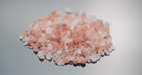 Pile of Pink Himalayan Salt Crystals on Gray Surface