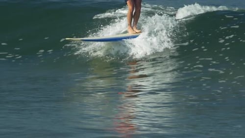Surfer Riding Wave on a Surfboard in Ocean