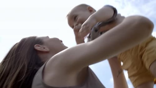 Mother Lifting Adorable Boy in Air