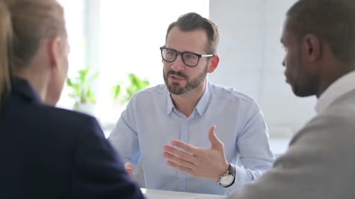 Businessman Scolding to Mixed Race Business People in Office