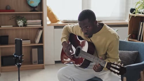 Man Plays Guitar at Home