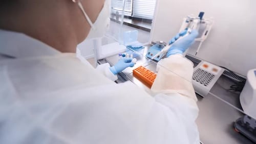 Scientist Handling Samples in Clean Lab Environment