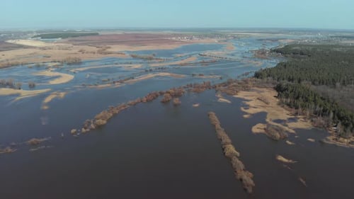 The Camera Flies High Above the Field Where the River Overflowed in the Spring