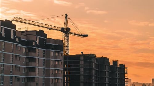 Construction Cranes Building Urban Structures During Sunrise