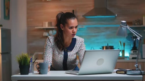 Tired Woman Working Late on Laptop at Home