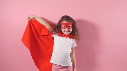Smiling Girl in Superhero Costume Poses Confidently